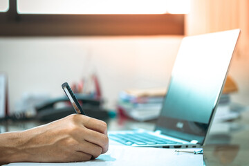 Businessman using tablet and laptop for working finance on an office desk. Businessman job typing on laptop close-up. Meeting report in progress.