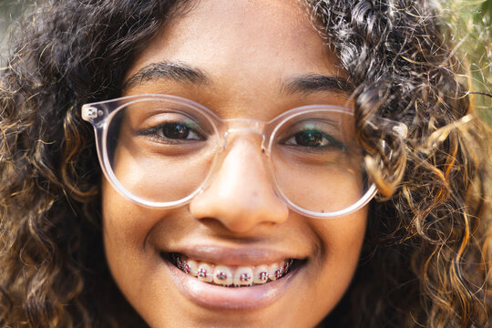 Close-up of a teenage girl smiling at the camera