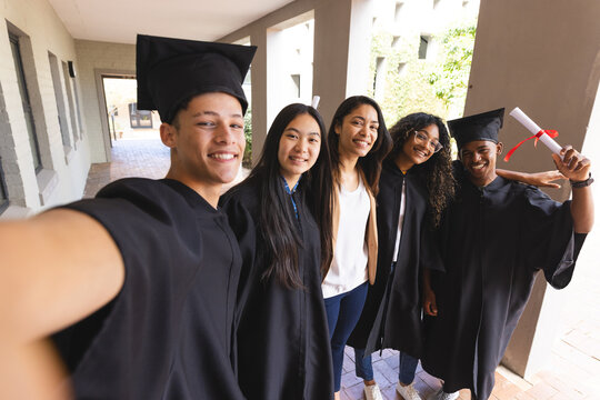 Diverse group of graduates pose for a selfie