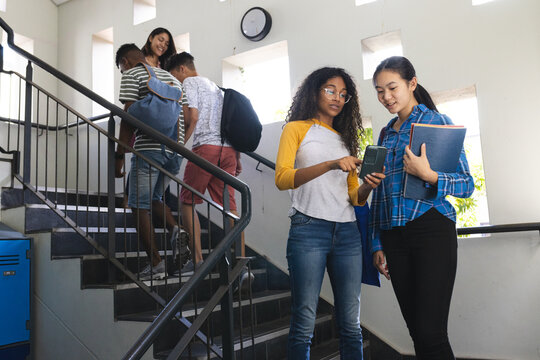 Diverse students gather in a high school stairwell