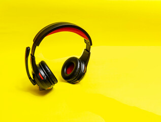 Wireless Over-Ear full size Headphones, Black leather isolated on yellow background .