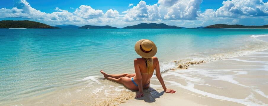 Young pretty woman sunbathing on the amazing sandy beach. Happy holiday theme.