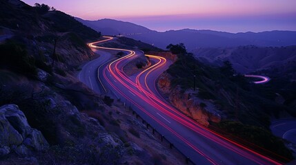 High speed motion blur from cars driving on a winding scenic road at twilight - obrazy, fototapety, plakaty