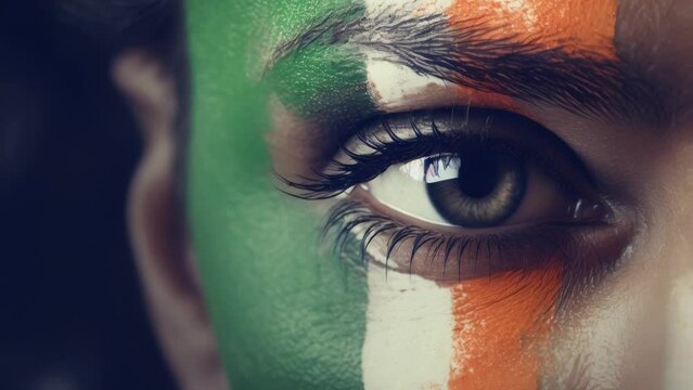 Close up of a person's face painted in the colors of the Indian flag. Great for cultural events or patriotic themes.