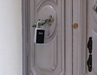 Smart key lock mounted on bars on the window for renting apartment. Safe Key Box is used when the...