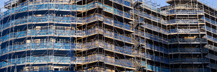 Scaffolding surrounding residential development for safe access to construction work