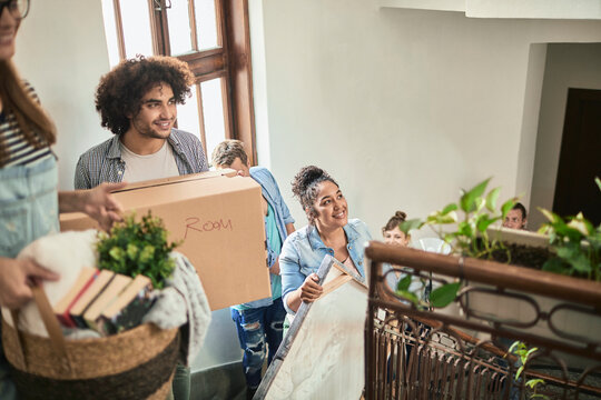 Group of young people moving into their new apartment