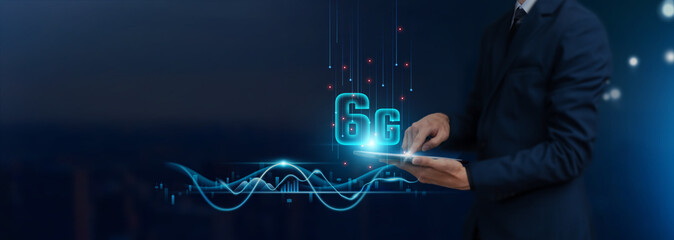 6G Technology Concept: Businessman uses tablet on Advanced Global Networking, Connectivity, Innovation, Development, to develop smart solutions from digital technology