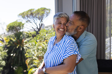 Senior biracial couple shares a tender moment at home
