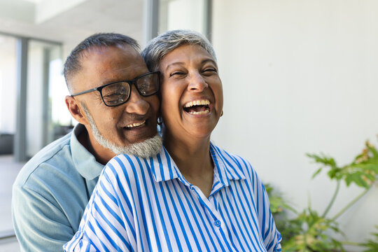 Senior biracial couple shares a joyful moment, with copy space