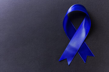 Royal Blue Awareness Ribbon on Dark Background, Copy Space