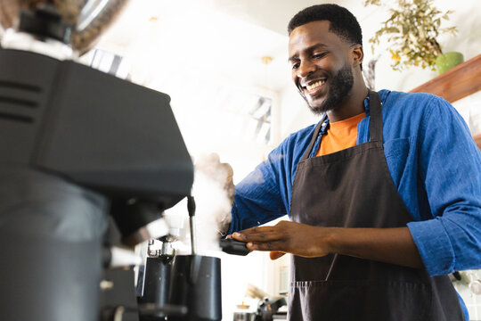 African American barista prepares coffee at a cafe, with copy space