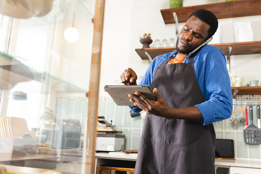 African American man taking inventory in a cafe, with copy space