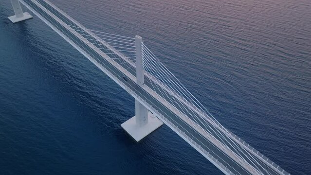 Aerial view of cars crossing the calm dark blue sea on the modern bridge. Drone top-down view.