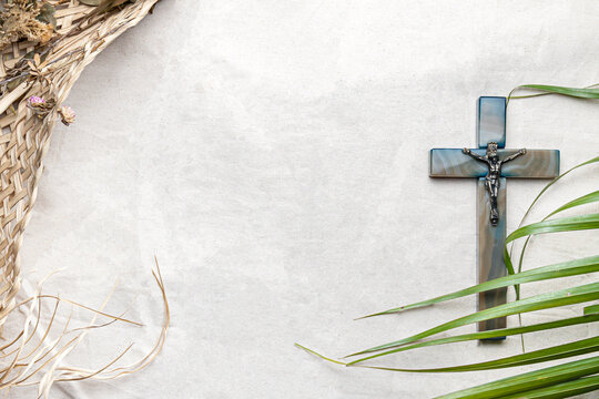 Palm Sunday background. Cross and palms on white cloth background