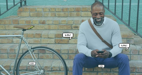 Image of lol text in speech bubbles over african american man using smartphone