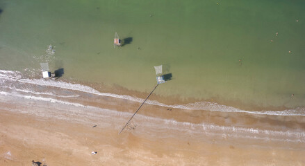 Aerial view of a sunny group of fishing hut´s in Tharon beach, France
