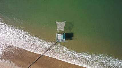 Aerial view of fishing hut in Tharon beach, Saint Michel Chef Chef with waves