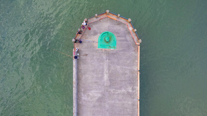 overhead aerial view of the lighthouse with fishermen