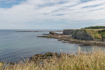 St. Baldred's Boat rocky outcrop at Seacliff beach in the distance, North Berwick, Scotland