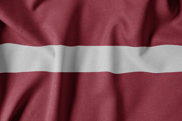 National Flag on Textured Fabric Background. Silk textured flag, realistic wave and flag look. LV  Flag of Latvia