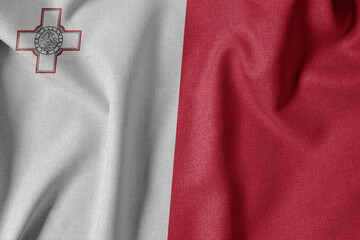 National Flag on Textured Fabric Background. Silk textured flag, realistic wave and flag look. MT  Flag of Malta