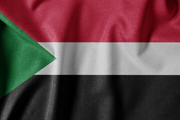 Fototapeta premium National Flag on Textured Fabric Background. Silk textured flag, realistic wave and flag look. SD Flag of Sudan