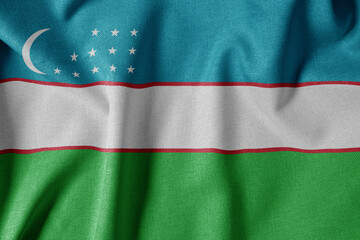 National Flag on Textured Fabric Background. Silk textured flag, realistic wave and flag look. UZ  Flag of Uzbekistan