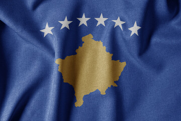 National Flag on Textured Fabric Background. Silk textured flag, realistic wave and flag look. XK Flag of Kosovo