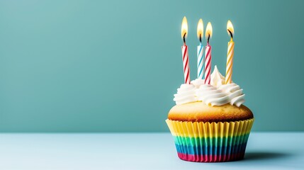 Cupcake with Four Candles on Turquoise Studio Background - Space for Copy Text