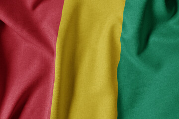 National Flag on Textured Fabric Background. Silk textured flag, realistic wave and flag look. GN  Flag of Guinea