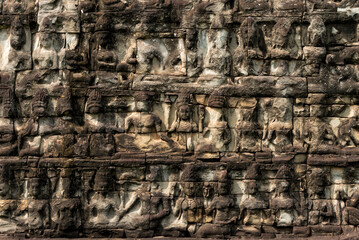 Carvings of apsaras on stone wall in Angkor Wat