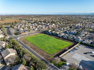 Fototapeta na wymiar Drone photos over vacant land in a community in a community in northern California. Green space vacant land. Commercial Real Estate