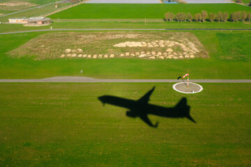 Shadow of a plane at an airport taking off