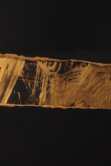 Gold, bronze, black crumble torn paper painting wall. Abstract glow texture copy space relief...