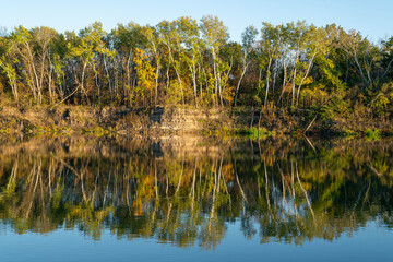 reflection of autumn trees in the water