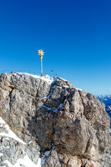 Naklejka na ściany i meble Golden cross on the German side of the Mount Zugspitze in Germany, Europe