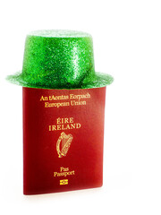 Green hat on passport of Ireland. Naturalization and getting Irish citizenship concept. White background.