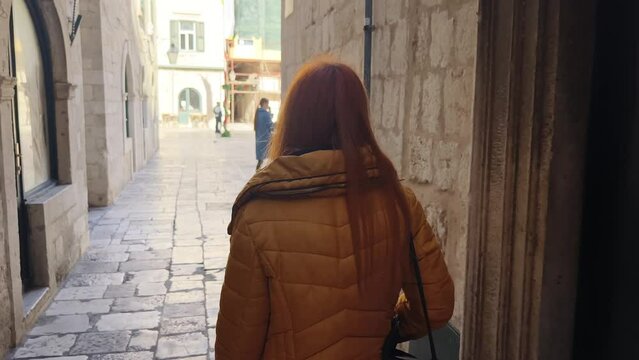 Woman tourist explore in old Mediterranean town of Dubrovnik in Croatia