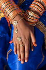 Hands of an Indian woman decorated with costume jewelry in Pushkar, India. Closeup