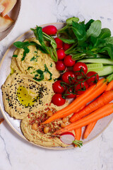 Hummus with fresh crispy vegetables. top view .