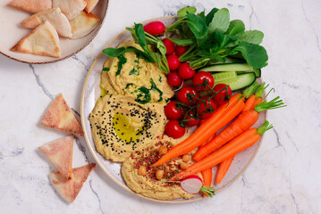 Hummus with fresh crispy vegetables. top view .