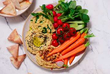 Hummus with fresh crispy vegetables. top view .