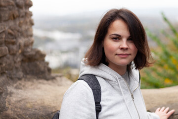 Portrait of a young woman in the ruins of an ancient fortress