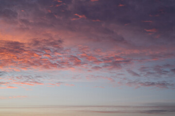 Layers of sunset. Fluffy clouds. Romantic sky. Universal vertical photo. The background picture.