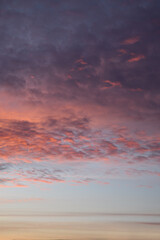 Layers of sunset. Fluffy clouds. Romantic sky. Universal vertical photo. The background picture.