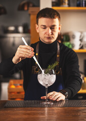 Expert barman is making cocktail