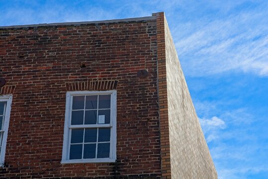 Brick building with  jack arch window lintel against blue sky