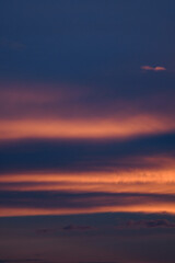 Bright blue clouds at sunset. Yellow lines, romantic sky. Light breaks through the clouds. Universal photos. The background picture.