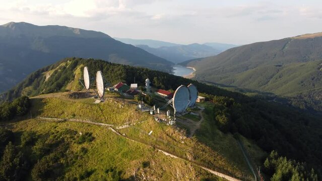 Aerial view of the big parabolic antenna of the radio station abandoned on the top of Monte Giogo, used during cold war. Comano, Massa and Carrara province, Lagastrello lake, Tuscany, Italy. 